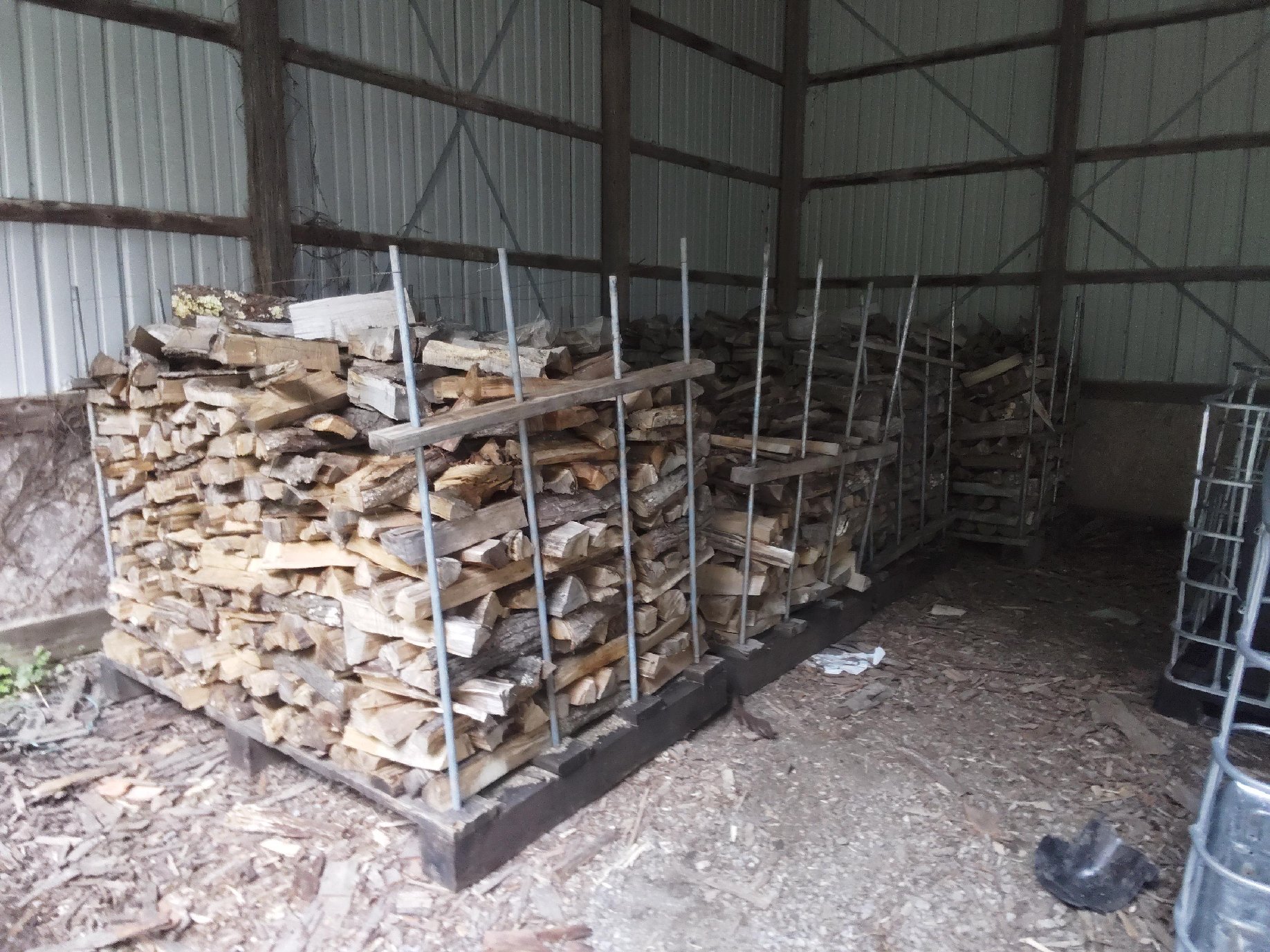 Kiln-Dried Mixed Hardwood - Professional indoor storage facility with organized firewood racks